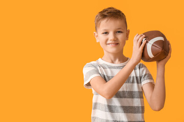 Sticker - Cute little boy with rugby ball on color background