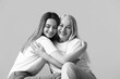 © Pixel-Shot - Black and white portrait of young woman and her mother on grey background