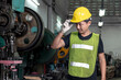 © lukyeee_nuttawut - engineer wear safety helmat for checking and inspects quality of industrail machine in factory
