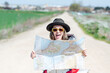 © Miguel Lifestyle - happy woman hiker with a map in her hand
