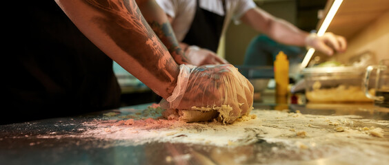 Man kneading dough for fresh bread