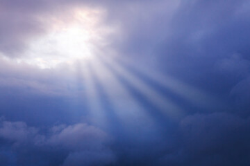 storm clouds, dark blue clouds, rays of the sun through the skylight, the concept of hope, faith, resurrection