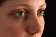 © WildMedia - Face of unhappy female in tears from close up in darkness. . lady black close up. Crying woman portrait in detail. Upset blonde girl with blank look.