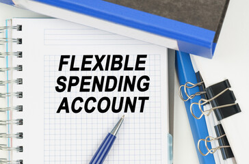 Among the documents, folders, a notebook with the inscription - FLEXIBLE SPENDING ACCOUNT