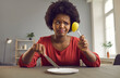 © Studio Romantic - Unhappy slimming african american woman hunger grimacing and frowning looking at small apple piece on fork. Young back female with sad and depressed expression on balanced diet for weight loss