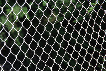 Full frame selective focus close-up view of a segment of a chainlink fence