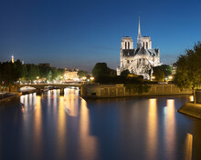 France, Ile-de-France, Paris, Long Exposure Of Seine River Canal At Dusk With Notre-Dame De Paris In Background