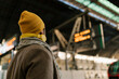 © Ezequiel Gim√©nez/Westend61 - Man wearing knit hat checking arrival departure board while standing at station
