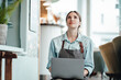 © Joseffson/Westend61 - Female entrepreneur with laptop looking up in coffee shop