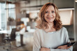 © Joseffson/Westend61 - Elegant female entrepreneur with arms crossed in office