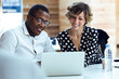 © JOSEP SURIA/Westend61 - Male and female colleagues using laptop while sitting at desk in office