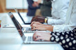 © JOSEP SURIA/Westend61 - Business colleagues typing while using laptop at desk in coworking office