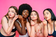 © OneInchPunch/Westend61 - Group of multi-ethnic female models in lingerie applying make-up against pink background