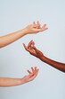 © OneInchPunch/Westend61 - Women stretching hands toward each other against white background