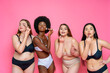 © OneInchPunch/Westend61 - Multi-ethnic group of female models in lingerie applying make-up while standing against pink background