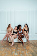 © OneInchPunch/Westend61 - Happy multi-ethnic group of fashion models in lingerie against white wall
