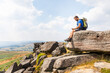 © William Perugini/Westend61 - Young male hiker using smart phone while sitting on top of mountain during vacations