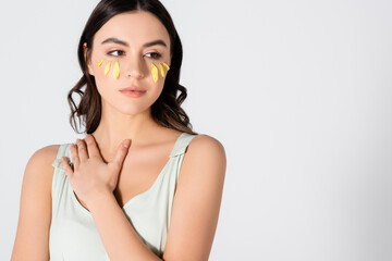 Sticker - young brunette woman with yellow petals on face isolated on white