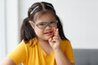© Bangkok Click Studio - Portrait of a young down syndrome girl wearing eyeglasses in beautiful and colorful clothes looking at camera with a self-confident and wildly open smile with happiness. Idea for happy disabled kid