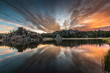 dramatic summer sunrise with the sky and clouds reflecting on the still Sylvan Lake in the Black Hills of South Dakota.