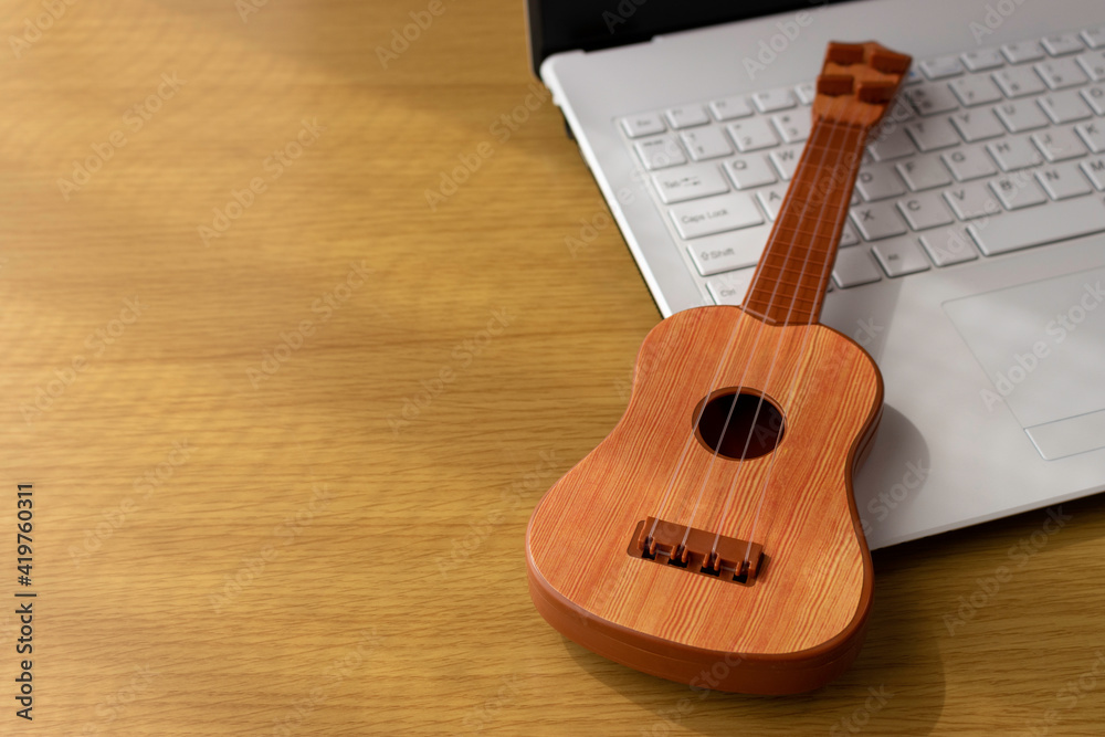 パソコンを見て練習するイメージ ノートパソコンとオモチャのギター Wall Mural Poko42