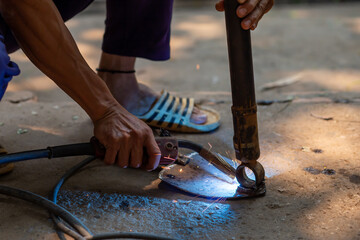 Wall Mural - Welding spark iron, not wearing safety gloves.