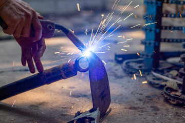 Wall Mural - Welding spark iron, not wearing safety gloves.