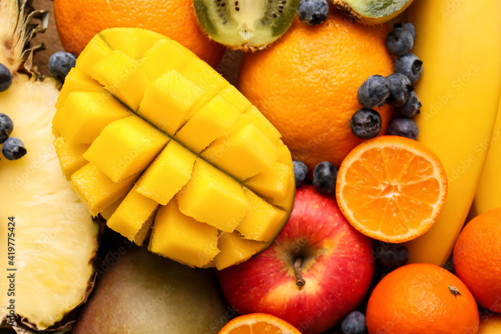 Different tropical fruits as background