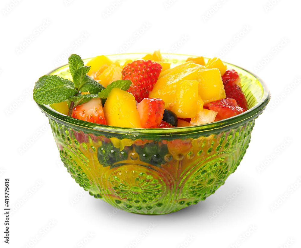 Bowl with tropical fruit salad on white background