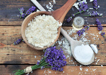 Spoon Full Of Flakes Of Soap With Essential Oil And Bunch Of Lavender With Bicarbonate On Wooden Background
