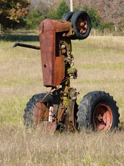 old rusty tractor upside down in field