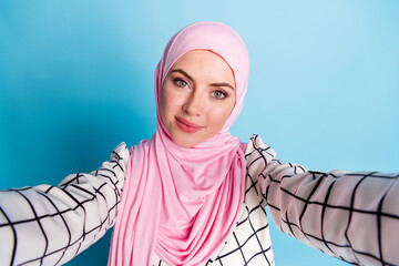 Wall Mural - Self-portrait of pretty cute cheery muslimah girl wearing fashionable clothing look outfit isolated over bright blue color background