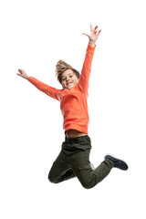 A 9-year-old boy in an orange sweater and jeans is jumping. Movement and energy. Isolated on white background. Vertical.