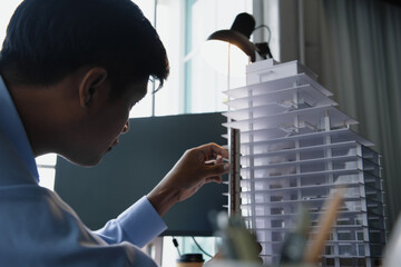 Architect's worked while sketching the details of the building, Design from his idea stationery on desk office. Startup and analysis about the architecture of the building.