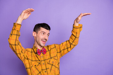 Sticker - Photo of funky charming young man wear plaid shirt bow tie dancing looking empty space isolated violet color background