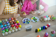 Handmade Or D.I.Y. Painted Easter Eggs. Lady And Child Using The Paintbrush To Paint The Colorful Easter Eggs.