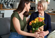 © gpointstudio - Daughter giving her mother flowers