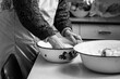 Close up photo of old baker's hands kneading dough for bread. The old woman's hands at work with the dough. Retro look.
Black and white photo of a woman's hands. Soft selective focus, art noise