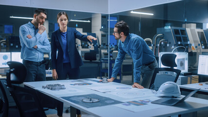 Poster - Factory Office Meeting Room: Team of Engineers Gather Around Conference Table, They Discuss Project Blueprints, Inspect Mechanism, Find Solutions, Use Laptop. Industrial Technology Factory