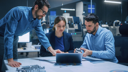 Poster - Factory Office Meeting Room: Team of Engineers Gather Around Conference Table, They Discuss Project Blueprints, Inspect Mechanism, Find Solutions, Use Laptop. Industrial Technology Factory