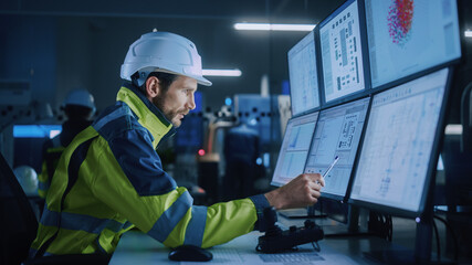 Fototapete - Industry 4.0 Modern Factory: Facility Operator Controls Workshop Production Line, Uses Computer with Screens Showing Complex UI of Machine Operation Processes, Controllers, Machinery Blueprints