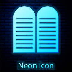 Sticker - Glowing neon The commandments icon isolated on brick wall background. Gods law concept. Vector