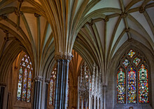 Piers Or Columns With Arched Vaulting Ribs, Ceiling Detail With Stained Glass Windows In The Interior Of The Wells Cathedral In Wells, Somerset, England.
