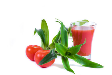 Tasty tomato juice in glass, greens, two raw tomatoes isolated on white background. Copy space