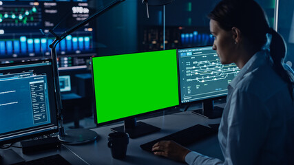 Poster - Female Software Engineer Working in a Modern Monitoring Office with Green Screen Mock Up on a Computer Display. Monitoring Room Big Data Scientists and Managers Sit in Front of Computers.