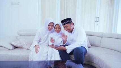 Wall Mural - Muslim family doing a video call with grandparents