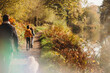Family walking along path by canal in fall