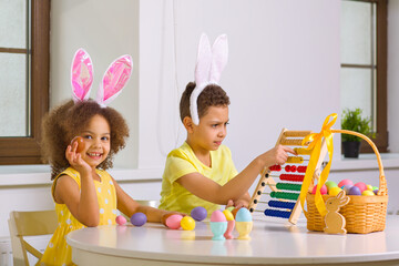 Wall Mural - A Black African-American boy and his sister count eggs collected during the Easter holiday on their abacus