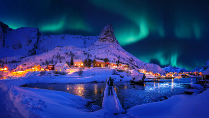 impressive winter scenery. northern lights appear over reinefjord, lofoten islands. norway. lofoten 