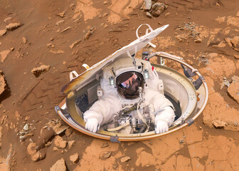 Wall Mural - single space astronaut on the helmet on the mars surface. mars colonization concept. elements of thi